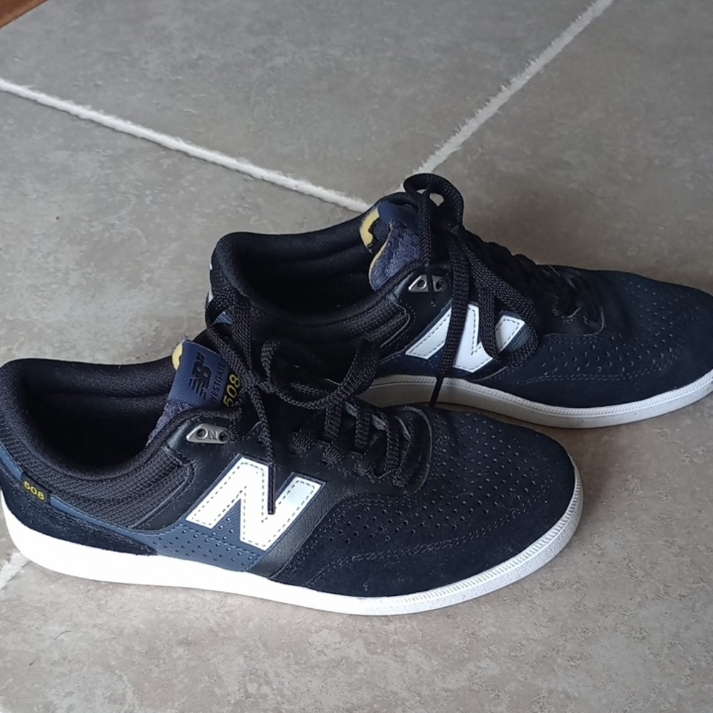 A) New Balance Black and White Sneakers